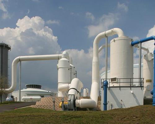 Large white storage tanks and piping outside the SMRU Water Treatment Facility